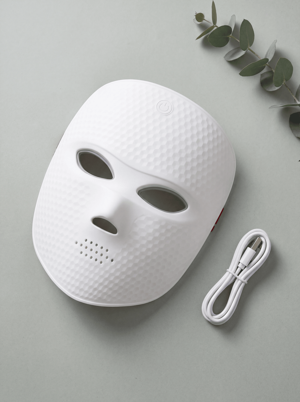 LumaGlow LED face mask textured variant flat lay with USB charging cable