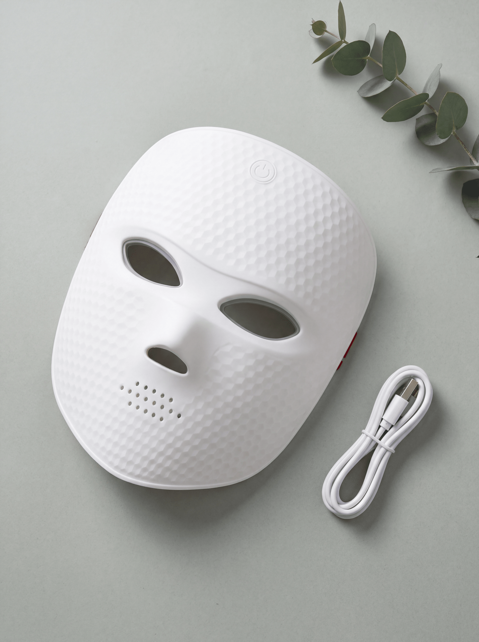 LumaGlow LED face mask textured variant flat lay with USB charging cable